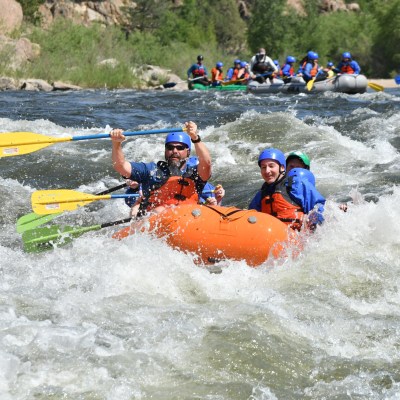 a group of people on a raft in a body of water