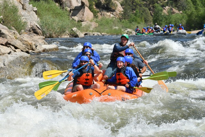 a group of people riding on a raft in a body of water