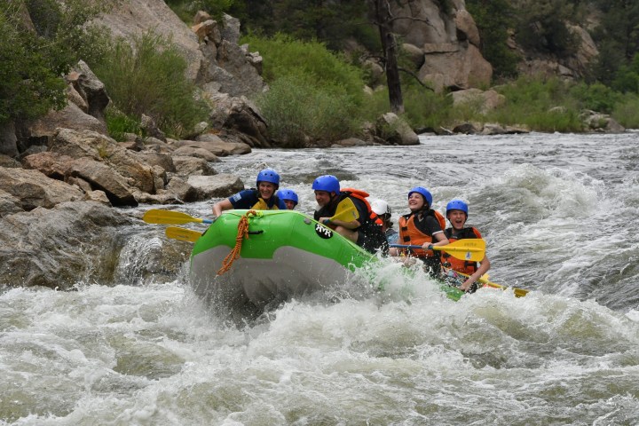 a group of people on a raft in a body of water
