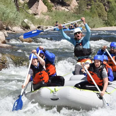 a group of people riding on a raft in the water