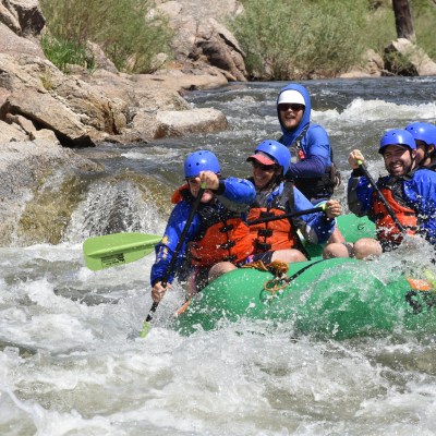 a group of people riding on a raft in a body of water