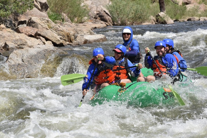 a group of people riding on a raft in a body of water