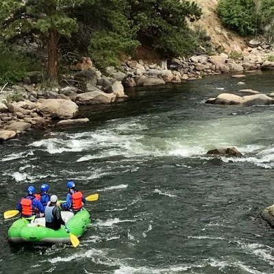 a group of people on a raft in a body of water