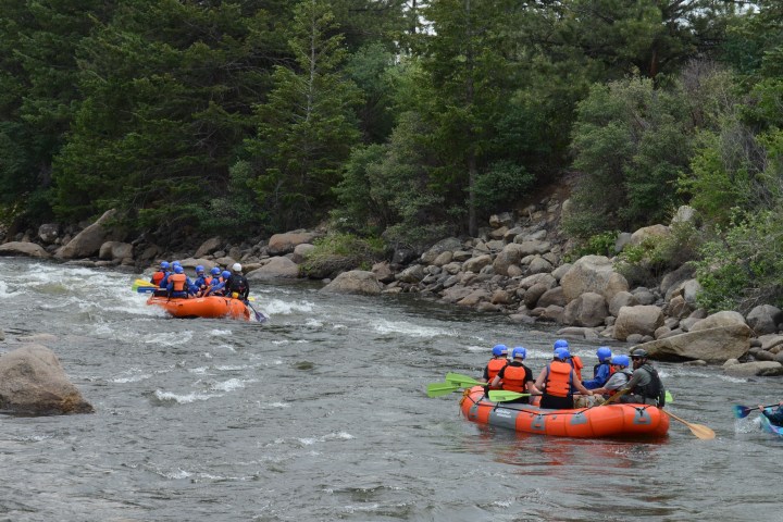 a group of people on a raft in a body of water