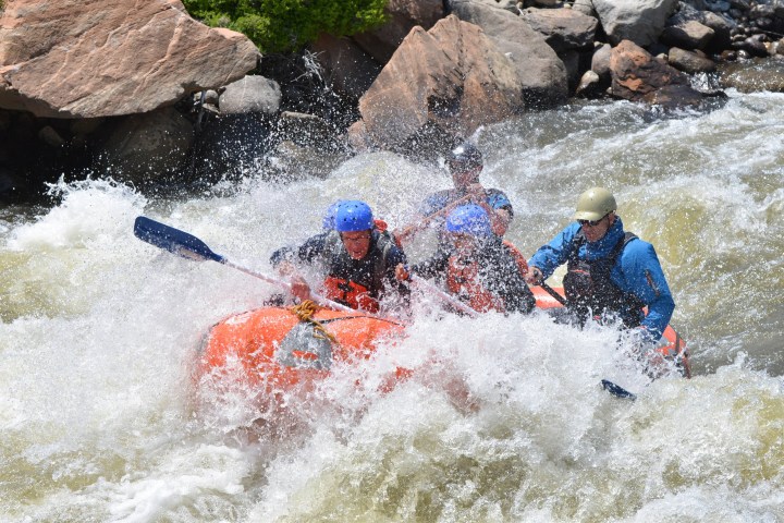a group of people riding on a raft in a body of water