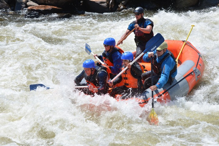 a man riding on a raft in a body of water