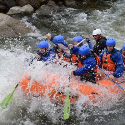 a group of people riding skis on a raft in the water