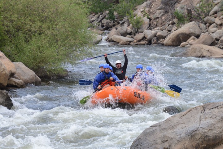 a group of people on a raft in a body of water