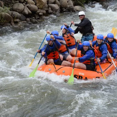 a group of people riding on a raft in a body of water