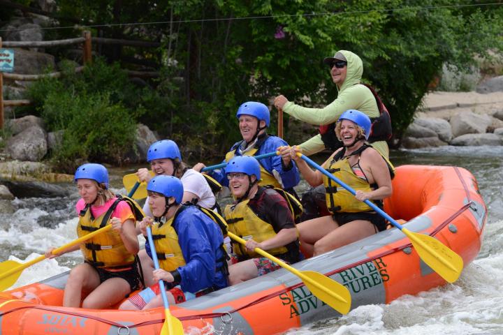 a group of people sitting on a raft